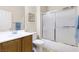 Bathroom with shower-tub combo, framed art, and a wooden vanity with sink at 2538 Capella Star St, Henderson, NV 89044