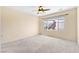 This empty bedroom has neutral paint, a ceiling fan, and a bright window at 2538 Capella Star St, Henderson, NV 89044