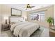 Relaxing bedroom featuring neutral decor, a ceiling fan, and a bright window at 2538 Capella Star St, Henderson, NV 89044