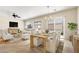Relaxing living room and dining area with a ceiling fan and lots of natural light at 2538 Capella Star St, Henderson, NV 89044