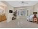 Sitting area in bedroom featuring natural light, neutral walls, and tile flooring at 2601 Harrisburg Ave, Henderson, NV 89052