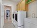 Well-lit laundry room featuring a washer and dryer, built-in cabinets, and a convenient utility sink at 2601 Harrisburg Ave, Henderson, NV 89052