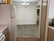 Open kitchen featuring white appliances, light wood cabinets, and views into adjacent rooms with modern lighting at 2725 S Nellis Blvd # 1158, Las Vegas, NV 89121