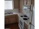 Well-lit kitchen includes white appliances, light wood cabinets, and window at 2725 S Nellis Blvd # 1158, Las Vegas, NV 89121