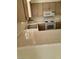 Kitchen with tile counters and backsplash, white appliances, stainless steel double sink, and light wood cabinets at 2725 S Nellis Blvd # 1158, Las Vegas, NV 89121