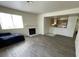The open living room features a fireplace, window, and wood floors for a cozy space at 2725 S Nellis Blvd # 1158, Las Vegas, NV 89121