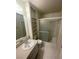 Neutral bathroom featuring a single sink vanity, framed mirror, shelves and walk-in shower at 2995 E Sunset Rd # 237, Las Vegas, NV 89120