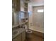 Neutral bathroom with a single sink vanity, framed mirror, shelves, and tub at 2995 E Sunset Rd # 237, Las Vegas, NV 89120