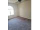 Neutral bedroom featuring carpet, white trim and a window at 2995 E Sunset Rd # 237, Las Vegas, NV 89120