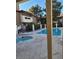 A pristine pool with lounge chairs, framed by trees, and surrounding apartments at 2995 E Sunset Rd # 237, Las Vegas, NV 89120
