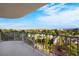 Expansive balcony showcasing city and mountain views framed by lush green trees below at 3111 Bel Air Dr # 7F, Las Vegas, NV 89109