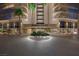 An entrance view of the Regency Towers building with palm trees and a circular garden at 3111 Bel Air Dr # 7F, Las Vegas, NV 89109