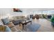 Bright living room showcasing stylish sofas, a glass coffee table, wood flooring, and balcony access at 3111 Bel Air Dr # 7F, Las Vegas, NV 89109