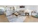 Bright living room with a glass coffee table, wood flooring, access to a balcony, and comfortable couches at 3111 Bel Air Dr # 7F, Las Vegas, NV 89109