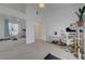 Bright bedroom with neutral carpet, ceiling fan, and an adjacent workstation area at 3320 Cactus Shadow St # 201, Las Vegas, NV 89129