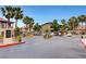 Cliff Shadows community entrance with gated access, lush palm trees, and desert landscaping at 3320 Cactus Shadow St # 201, Las Vegas, NV 89129