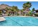 A community pool with plenty of seating surrounded by lush greenery and desert palm trees at 3320 Cactus Shadow St # 201, Las Vegas, NV 89129