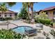 A community hot tub with seating, surrounded by palm trees and lush desert landscaping at 3320 Cactus Shadow St # 201, Las Vegas, NV 89129