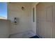 Exterior shot of a condo door with beige siding, a light fixture, and a fire extinguisher at 3320 Cactus Shadow St # 201, Las Vegas, NV 89129