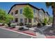 Tan two-story condo building with stairs, drought resistant landscaping, and a sidewalk at 3320 Cactus Shadow St # 201, Las Vegas, NV 89129