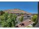 Community with lush landscaping, mature trees, and mountain views in the background at 3320 Cactus Shadow St # 201, Las Vegas, NV 89129