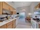 Bright kitchen with white appliances, light wood cabinetry, and open floorplan at 3320 Cactus Shadow St # 201, Las Vegas, NV 89129