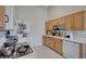 Bright kitchen with white appliances, white countertops and light wood cabinetry at 3320 Cactus Shadow St # 201, Las Vegas, NV 89129