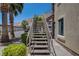 Exterior view of a staircase with metal railing leading up to a condo unit in a desert setting at 3320 Cactus Shadow St # 201, Las Vegas, NV 89129