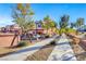 A view of a neighborhood street showcasing well-maintained townhomes and desert landscaping at 3320 Cactus Shadow St # 201, Las Vegas, NV 89129