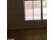 Bedroom featuring wood flooring and windows with blinds, offering natural light and privacy at 3435 Villa Knolls South Dr, Las Vegas, NV 89120