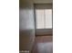 Bedroom with wood-look flooring, window with blinds and neutral paint at 3435 Villa Knolls South Dr, Las Vegas, NV 89120