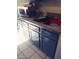 Kitchen featuring gray cabinets, granite countertops, stainless steel sink, microwave, and tiled floors at 3435 Villa Knolls South Dr, Las Vegas, NV 89120
