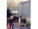 Kitchen with blue cabinets, granite countertops, range hood, and a variety of appliances at 3435 Villa Knolls South Dr, Las Vegas, NV 89120