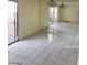 Bright living room featuring large sliding doors and tiled floors with mirrored wall and dining area at 3435 Villa Knolls South Dr, Las Vegas, NV 89120
