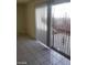 Bright living room featuring large sliding doors and tiled floors at 3435 Villa Knolls South Dr, Las Vegas, NV 89120