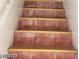 Interior staircase featuring red-tiled steps with golden accents at 3435 Villa Knolls South Dr, Las Vegas, NV 89120