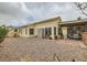 Exterior view of house with gravel yard, patio area, and window screens at 3473 Conough Ln, Las Vegas, NV 89129