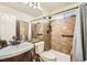 Well-lit bathroom featuring tiled shower with safety bars and modern fixtures at 3473 Conough Ln, Las Vegas, NV 89129