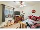 Fun bedroom with Coca-Cola decor, laminate floors, and a ceiling fan at 3473 Conough Ln, Las Vegas, NV 89129