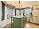 Lovely kitchen island with bar stool seating, a granite top, and great natural light from the adjacent windows at 3473 Conough Ln, Las Vegas, NV 89129