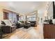 Spacious living room featuring hardwood floors, a large window, and comfortable seating arrangements, ideal for relaxation at 3473 Conough Ln, Las Vegas, NV 89129