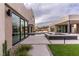 A modern backyard features a reflecting pool, sleek patio, and contemporary architecture at 3510 Cosima Ln, Las Vegas, NV 89120