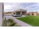 A modern backyard features a reflecting pool, sleek patio, and artificial grass at 3510 Cosima Ln, Las Vegas, NV 89120
