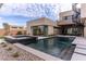 Backyard boasts a refreshing pool, spa, and sleek landscaping creating a private oasis at 3510 Cosima Ln, Las Vegas, NV 89120