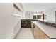Modern bar area with granite countertop, storage cabinets, and access to outdoors at 3510 Cosima Ln, Las Vegas, NV 89120
