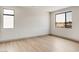 Modern bedroom featuring sleek hardwood floors and large windows at 3510 Cosima Ln, Las Vegas, NV 89120