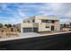 A modern house with a two-car garage, contemporary design, and drought-resistant landscaping at 3510 Cosima Ln, Las Vegas, NV 89120