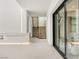 Modern hallway with floating linear fireplace and access to the outdoor living space at 3510 Cosima Ln, Las Vegas, NV 89120