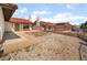 Spacious backyard featuring a stucco wall, desert landscaping, and a concrete patio at 411 Monmouth Ct, Henderson, NV 89015