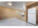 Kitchen open to living room with fireplace, white refrigerator, and tile flooring at 411 Monmouth Ct, Henderson, NV 89015